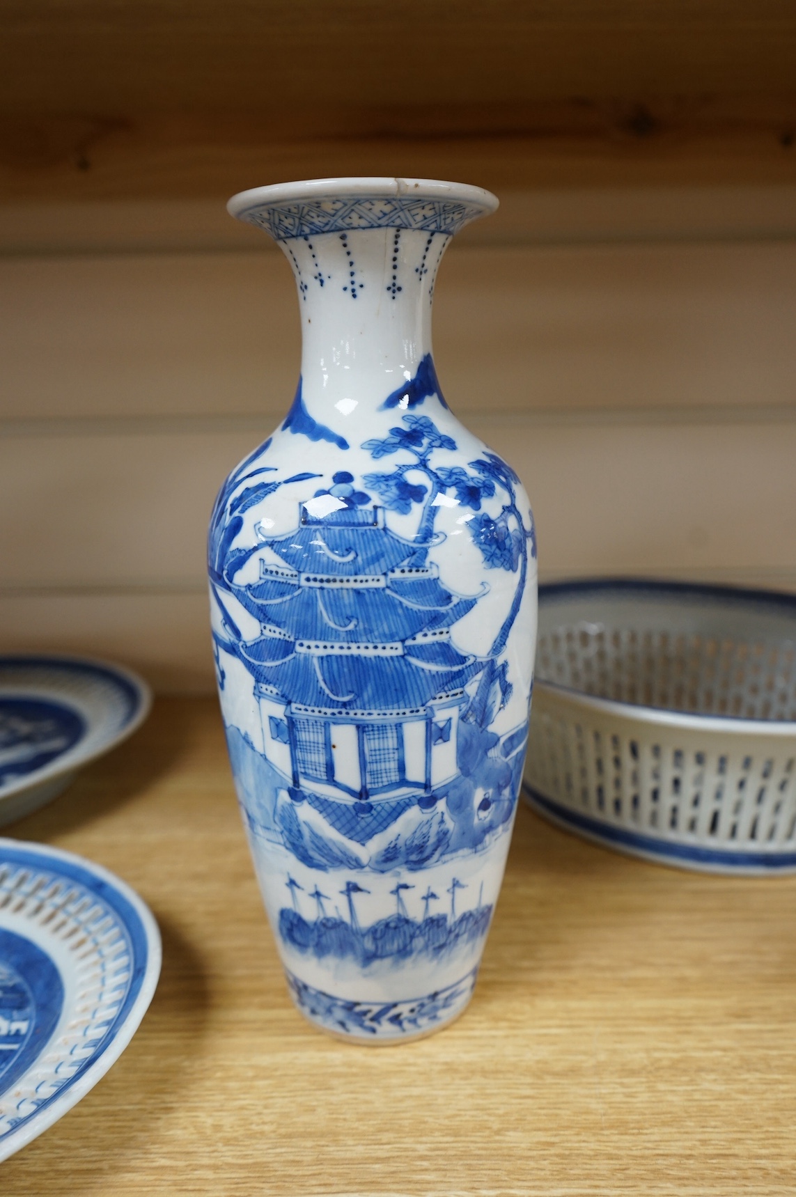 An early 19th century Chinese export blue and white chestnut dish, two related stands and a similar vase, largest 26cm high. Condition - fair
